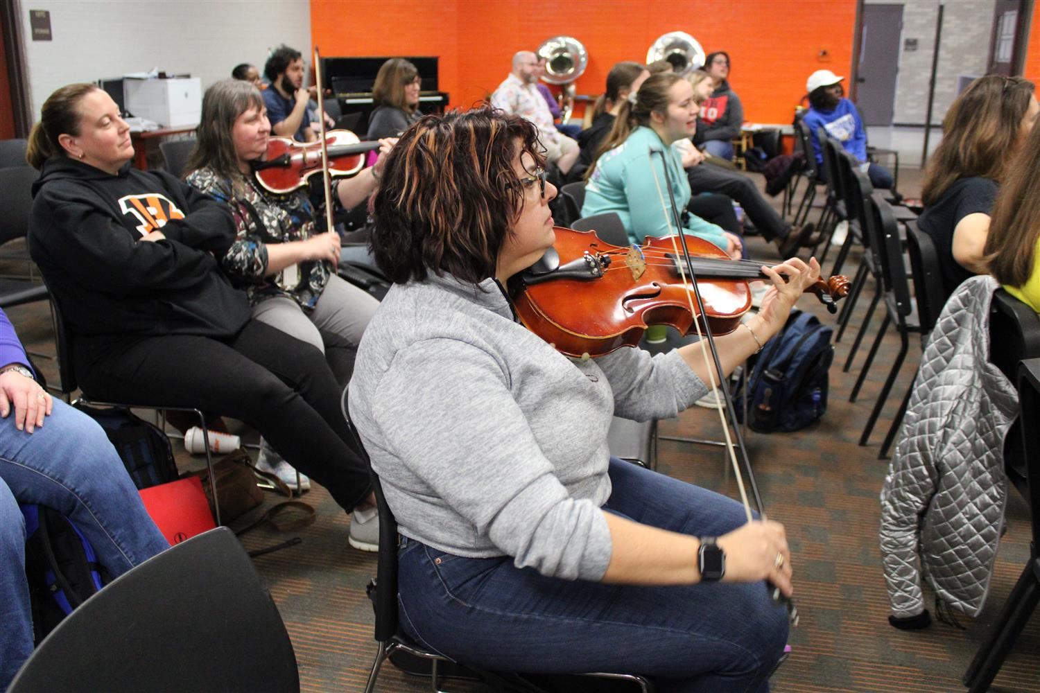 Teachers practice orchestra songs